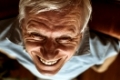 Closeup of senior man face toothy laugh